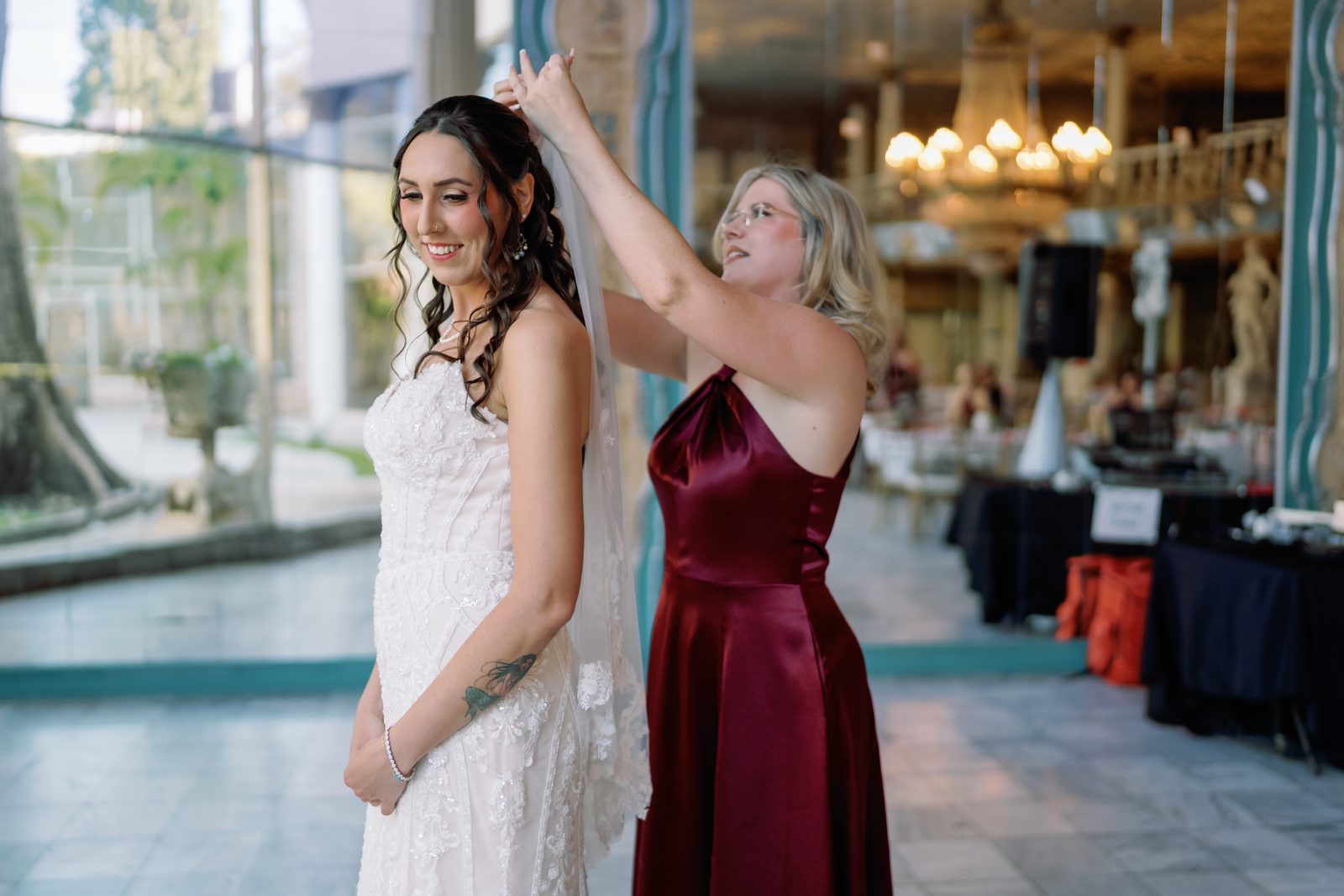 A bride's veil lifted in the light before the ceremony